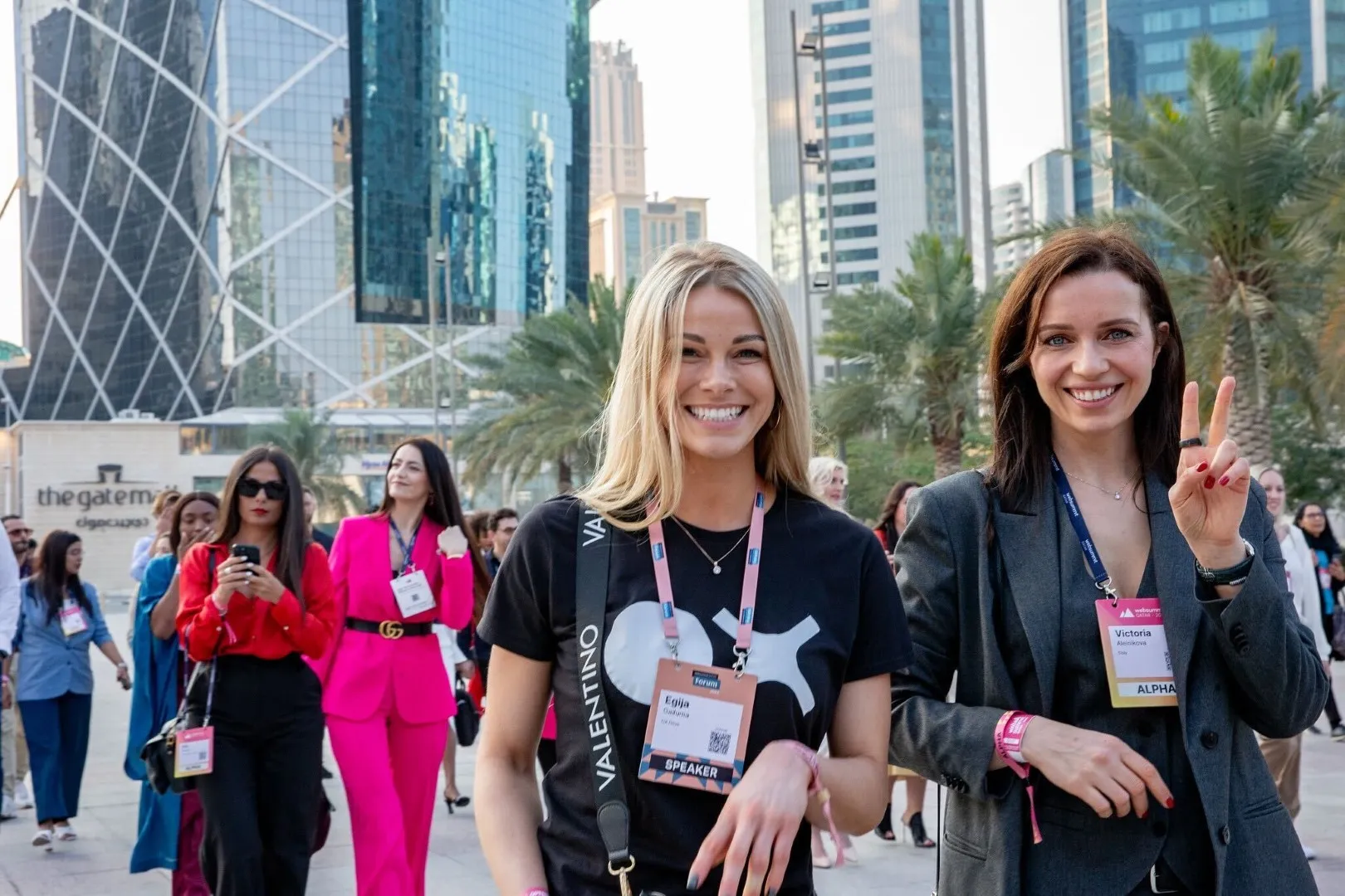 Two beautiful women standing next to each other.