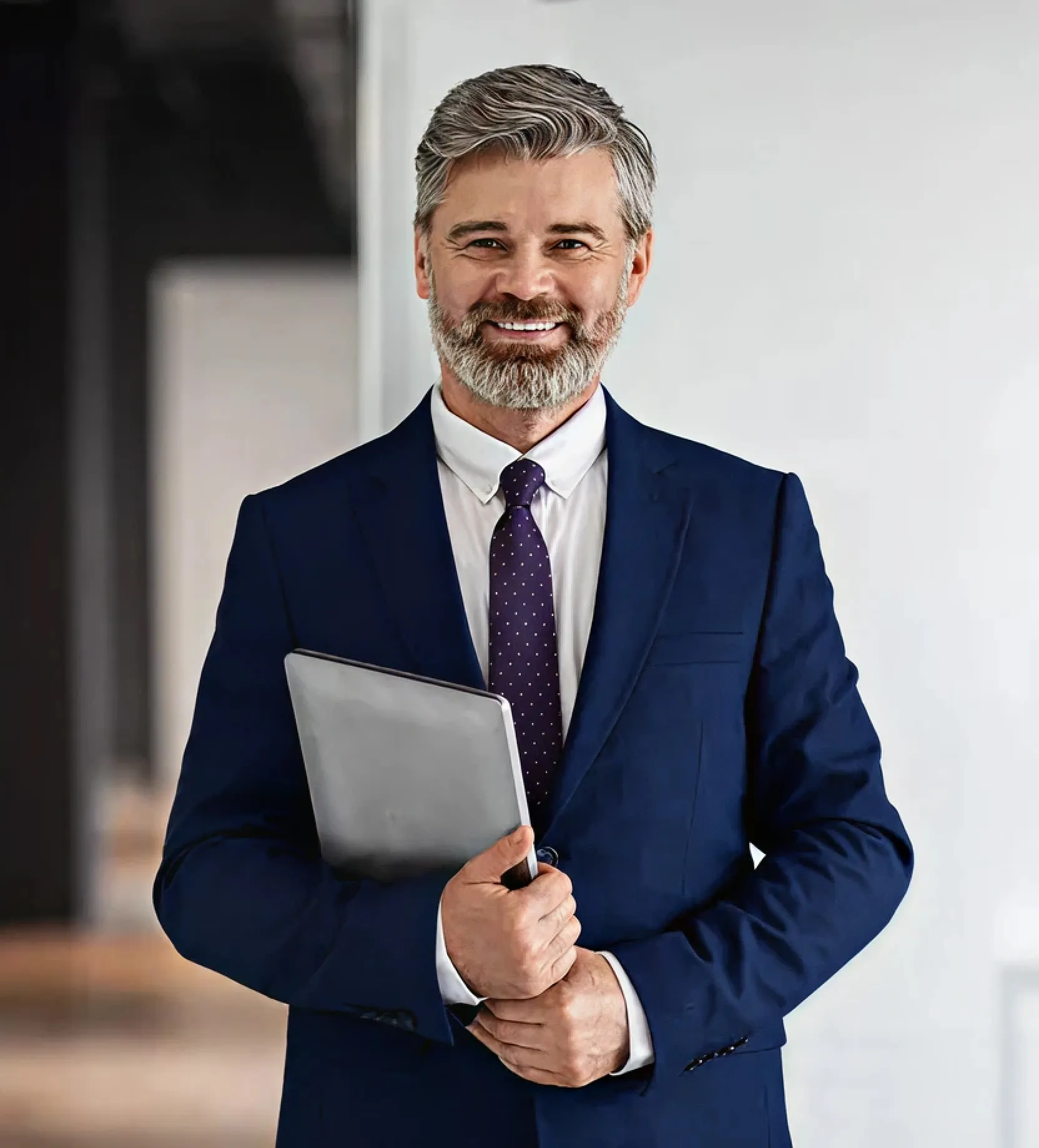 A man in a suit and tie holding a clipboard.